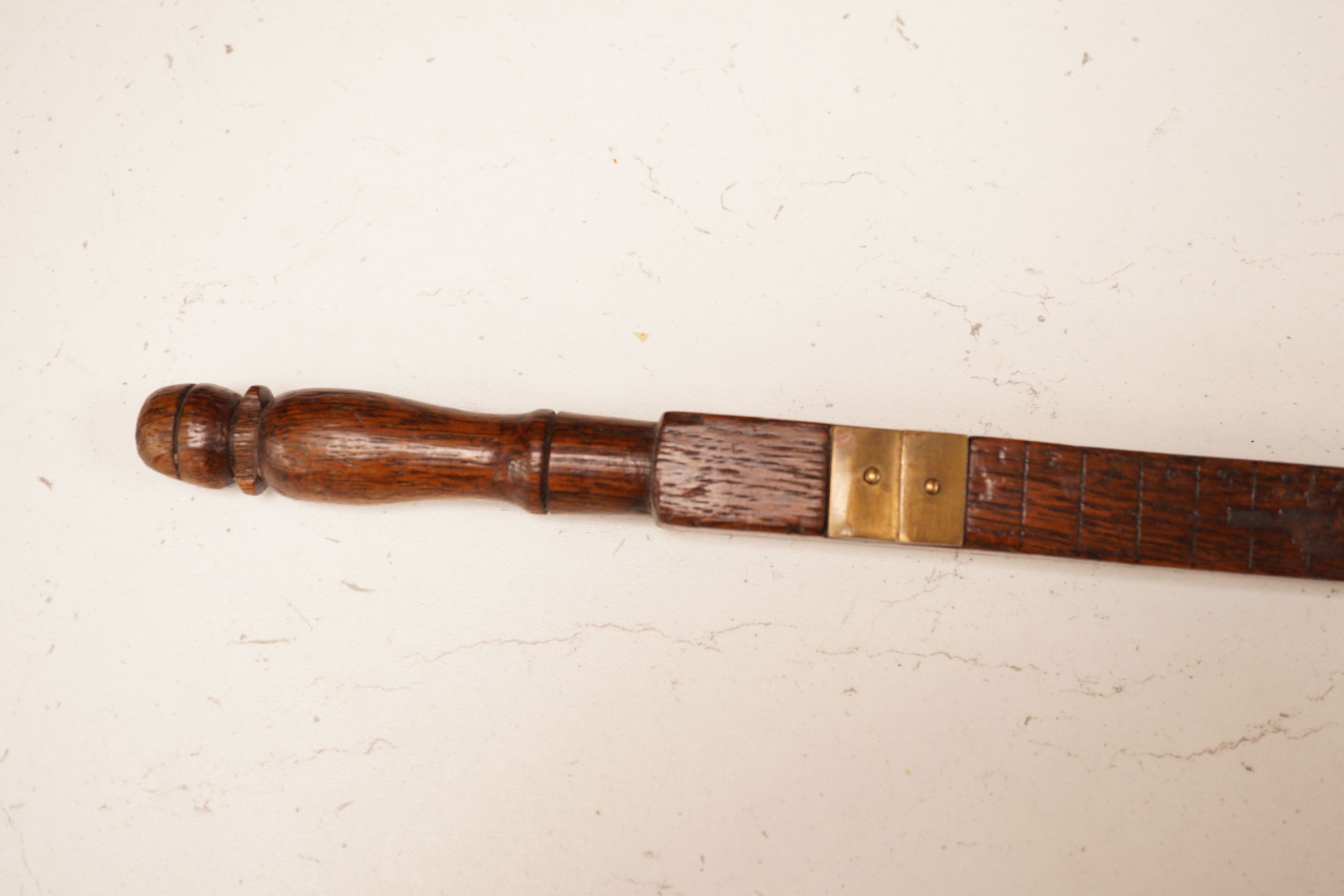 Three assorted 19th century treen measuring sticks to include a kingwood feather banded and marquetry inlaid measuring stick with stickware finial